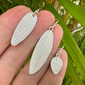 Handcrafted fine silver Sage Leaf Earrings showing authentic leaf veining and natural texture, molded from real garden sage leaves. Displayed on a hand against a greenery background by Coastalstyle Australia