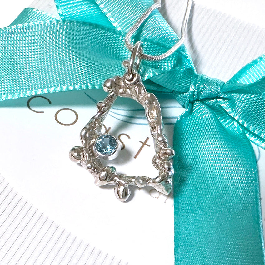 Handcrafted Argentium silver coral pendant featuring intricate branch-like texture with blue topaz gemstone, displayed on white sustainable gift box. Ocean-inspired ethical jewelry by Coastalstyle Australia