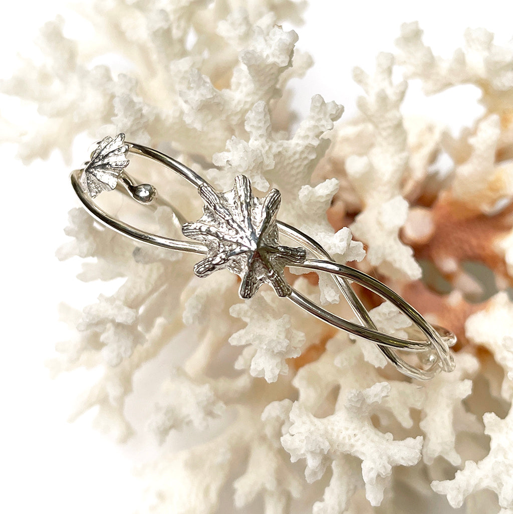 Tidal Cuff with pure silver limpet shells on a unique Argentium silver cuff, displayed on coral. Coastalstyle Australia