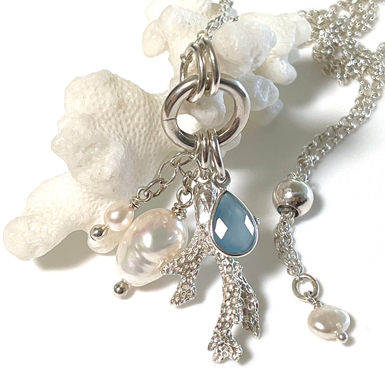 Close-up of the Ocean Magic Necklace by Coastalstyle Australia, showcasing a fine silver coral pendant with a faceted chalcedony stone and freshwater pearls.​