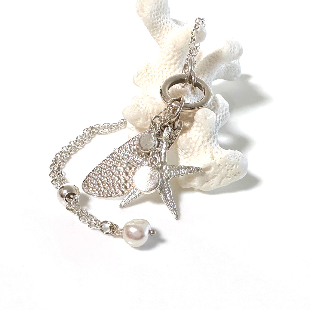 Sancast silver sea star and ocean inspired silver charms on an adjustable necklace