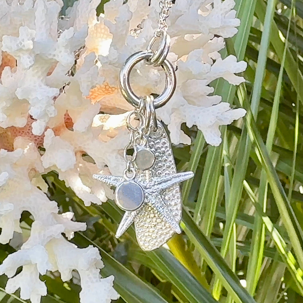 Sancast silver sea star and ocean inspired silver charms on an adjustable necklace