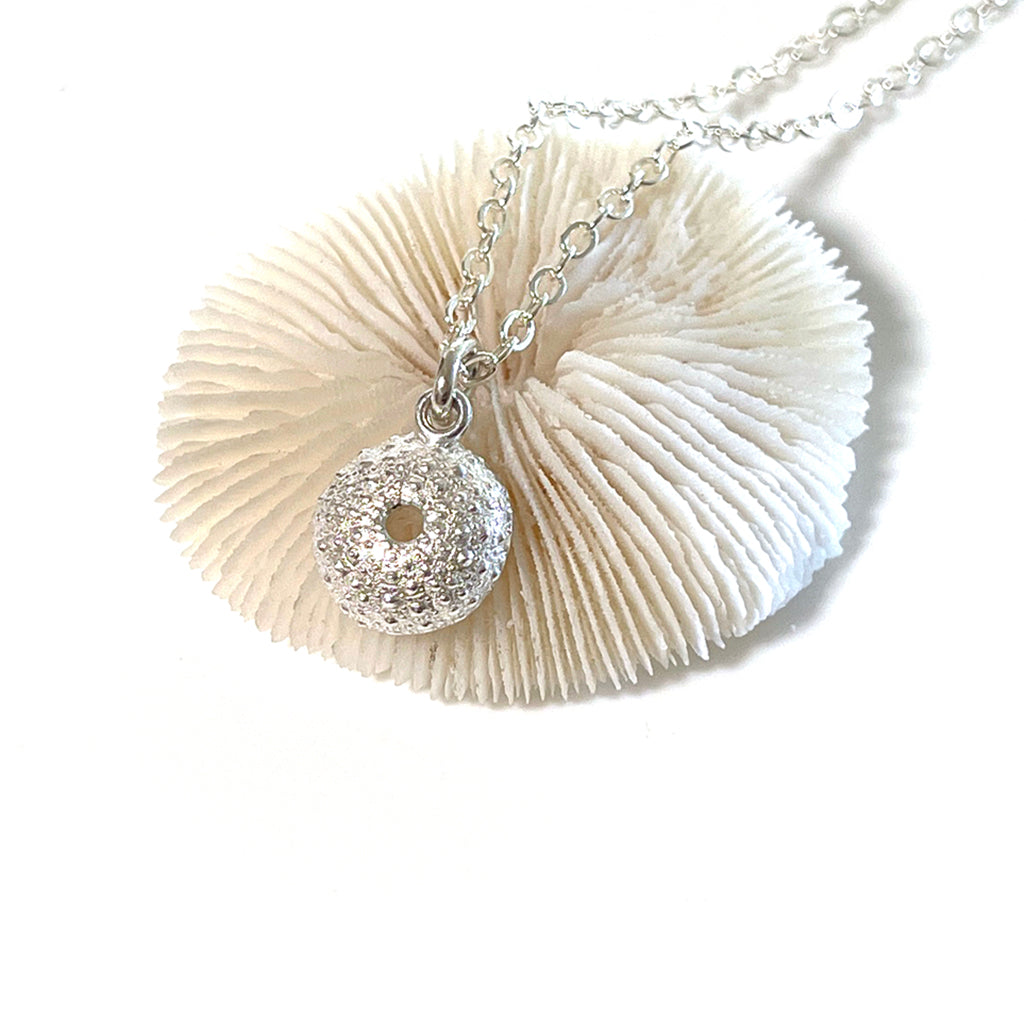 Handcrafted pure silver Sea Urchin Necklace featuring detailed texture moulded from real urchin shell, suspended on sterling silver chain on white background. Ocean-inspired jewellery by Coastalstyle Australia.