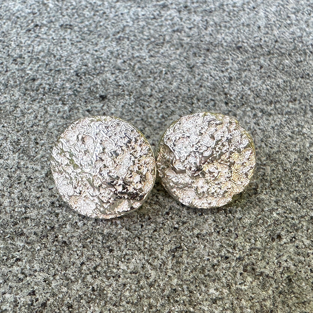 Handcrafted Beach Rock Earrings featuring smooth, rounded Pure silver forms from weathered coastal pebbles shown with shell. Minimalist ocean-inspired jewelry by Coastalstyle Australia.