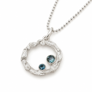 Pure silver Sapphire Reef Necklace on white background — open circle coral reef pendant with two bezel-set teal sapphires in different sizes on a silver ball chain. Ocean-inspired jewellery by Coastalstyle Australia"