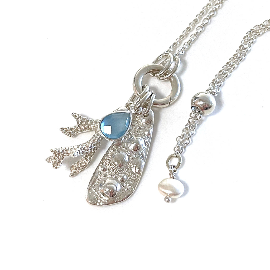 Close-up of the Hardy Reef Necklace by Coastalstyle Australia, showcasing a handcrafted pure silver coral pendant with a faceted chalcedony stone.​