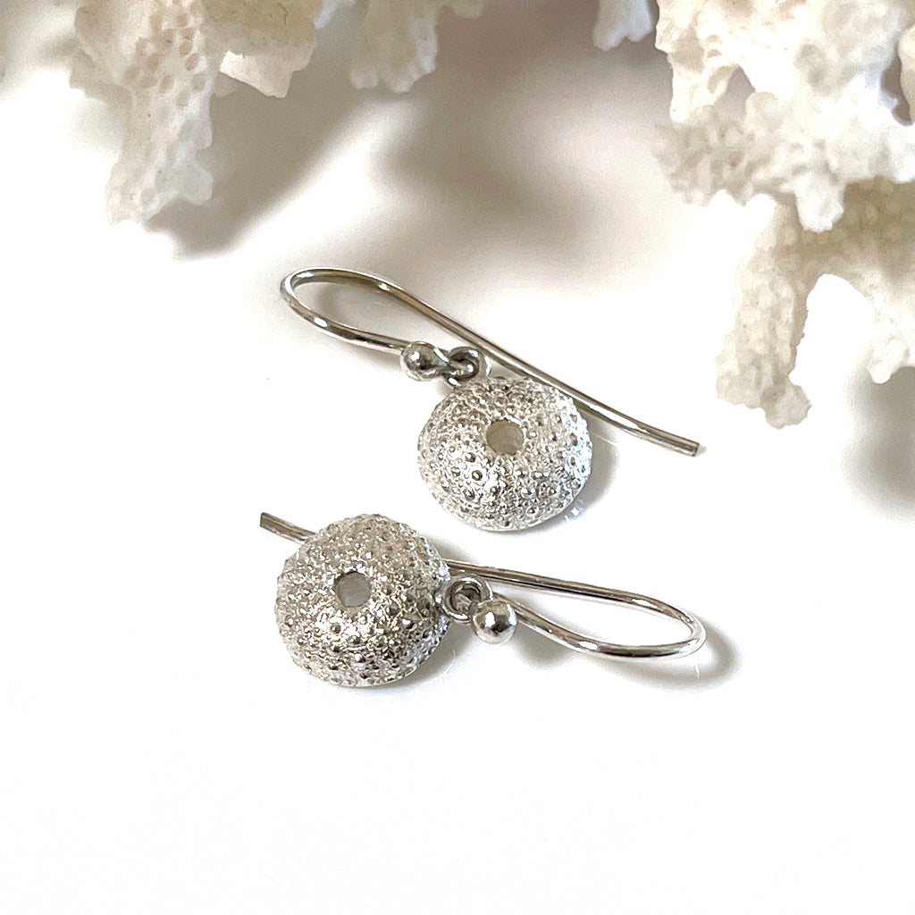 Handcrafted pure silver Sea Urchin Earrings featuring intricate natural texture molded from real urchin shells. Ocean-inspired jewelry by Coastalstyle Australia shown against neutral background with coral.